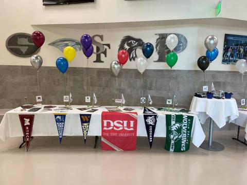 table with balloons and college material
