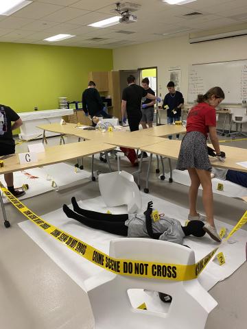 crime scene with mannequin and overturned chair