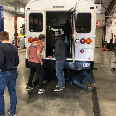 Auto Shop ALC students working on the bus