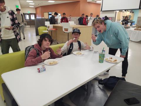 students at table eating waffles