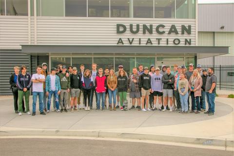 group of students in front of Duncan Aviation