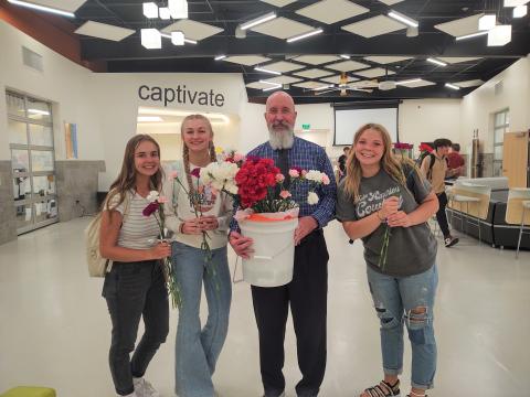group of students with Mr. Peery and flowers