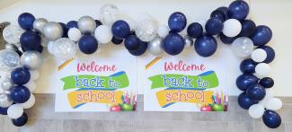 Welcome back sign with balloons